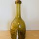 Amber colored Biot bubble glass bottle