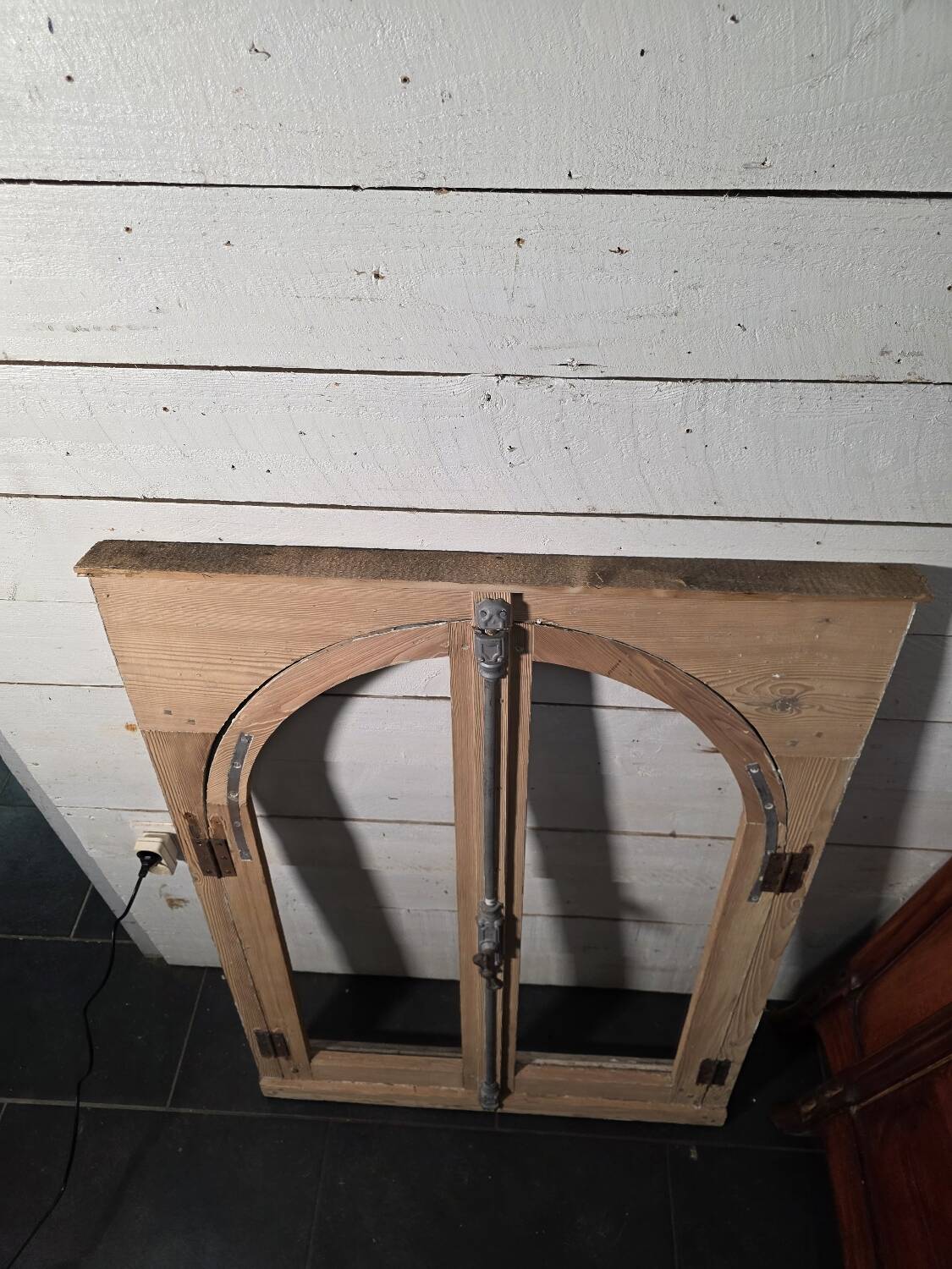 Old arched window made of fir wood