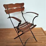 Folding garden chair with teak slats on a wrought iron structure