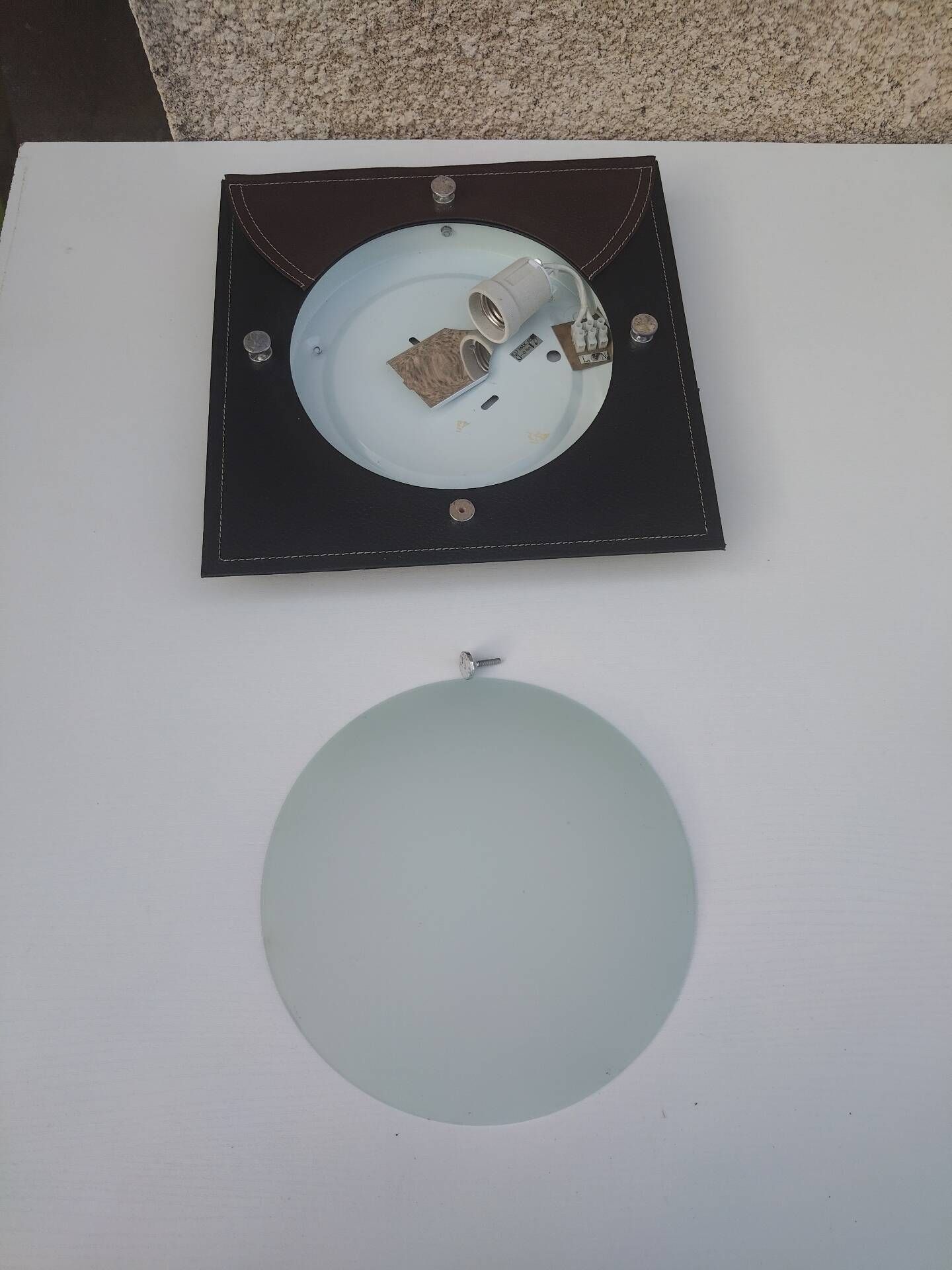 Wall light or ceiling light in frosted glass and leather-like material.