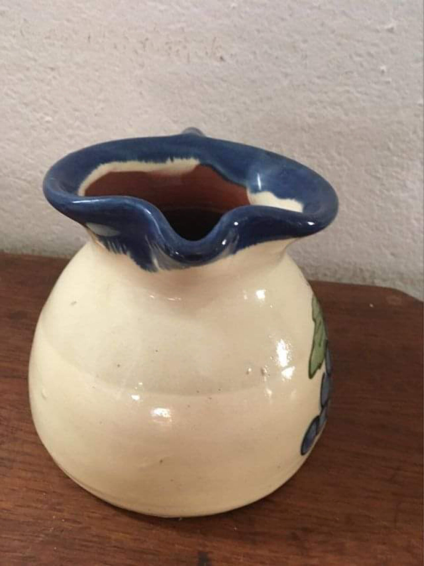 Terracotta jug with grape decoration.