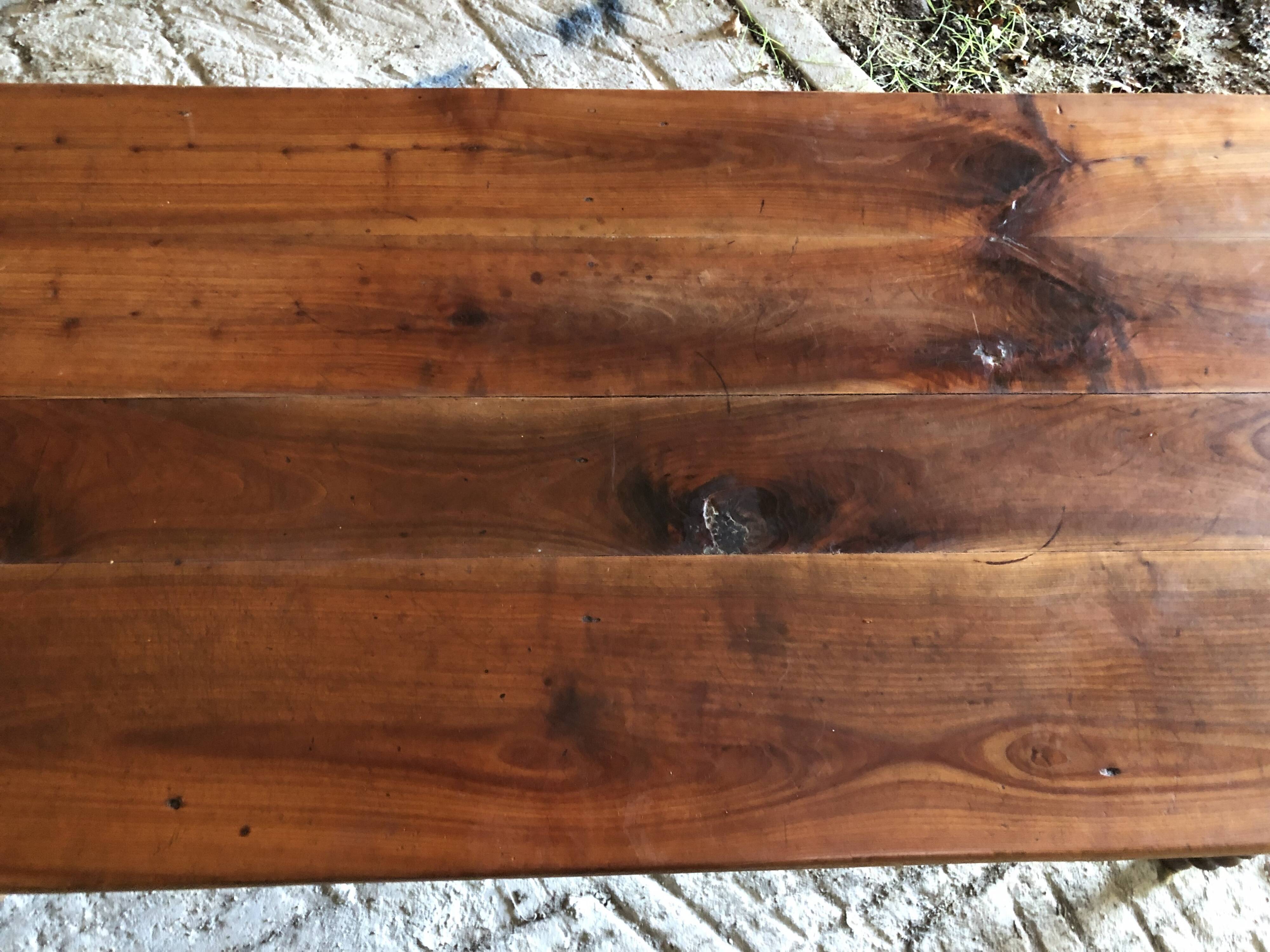 Antique Louis Philippe style farm table in solid cherry wood with turned base.