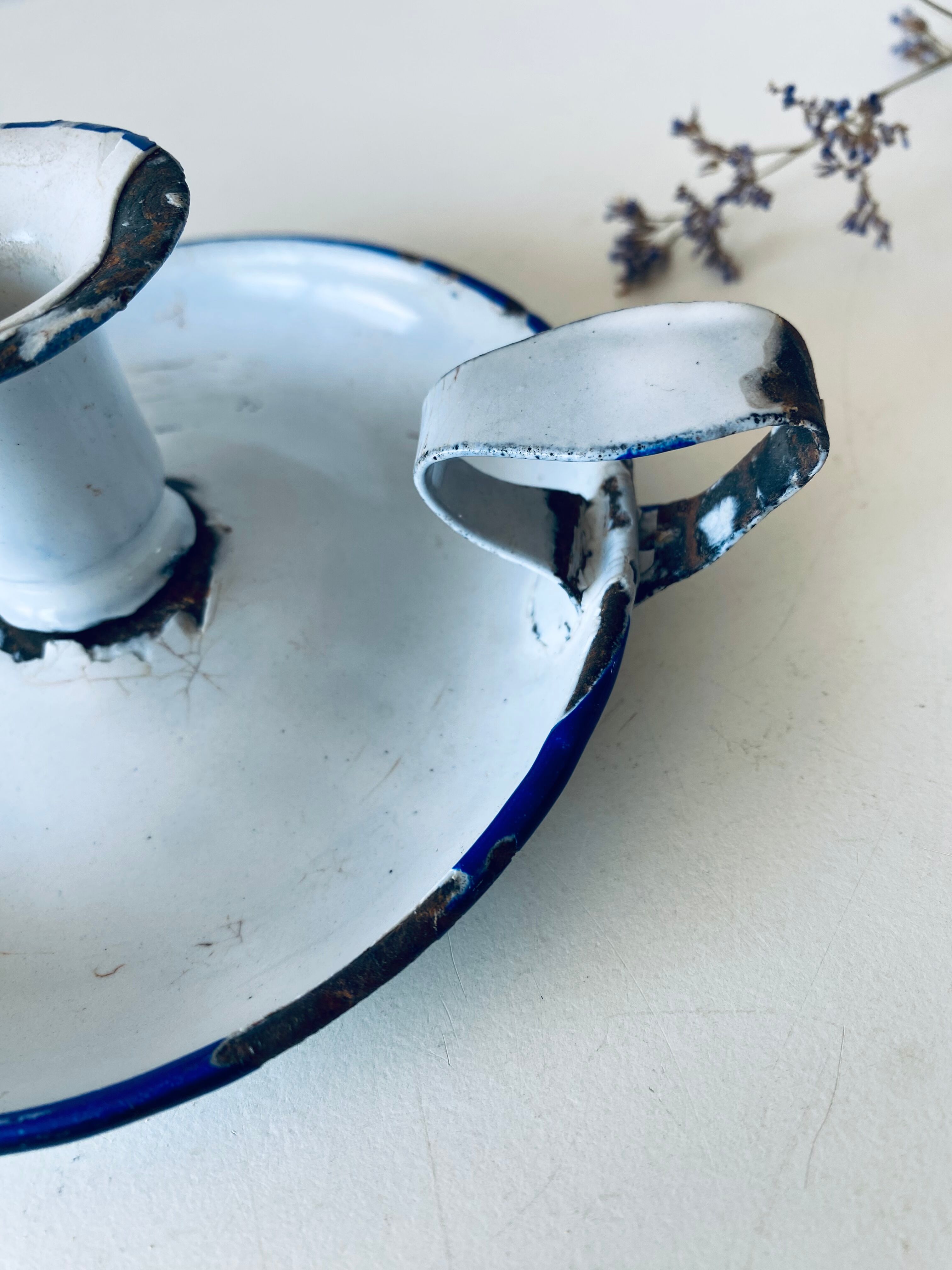 Antique candle holder in white and blue enamelled metal