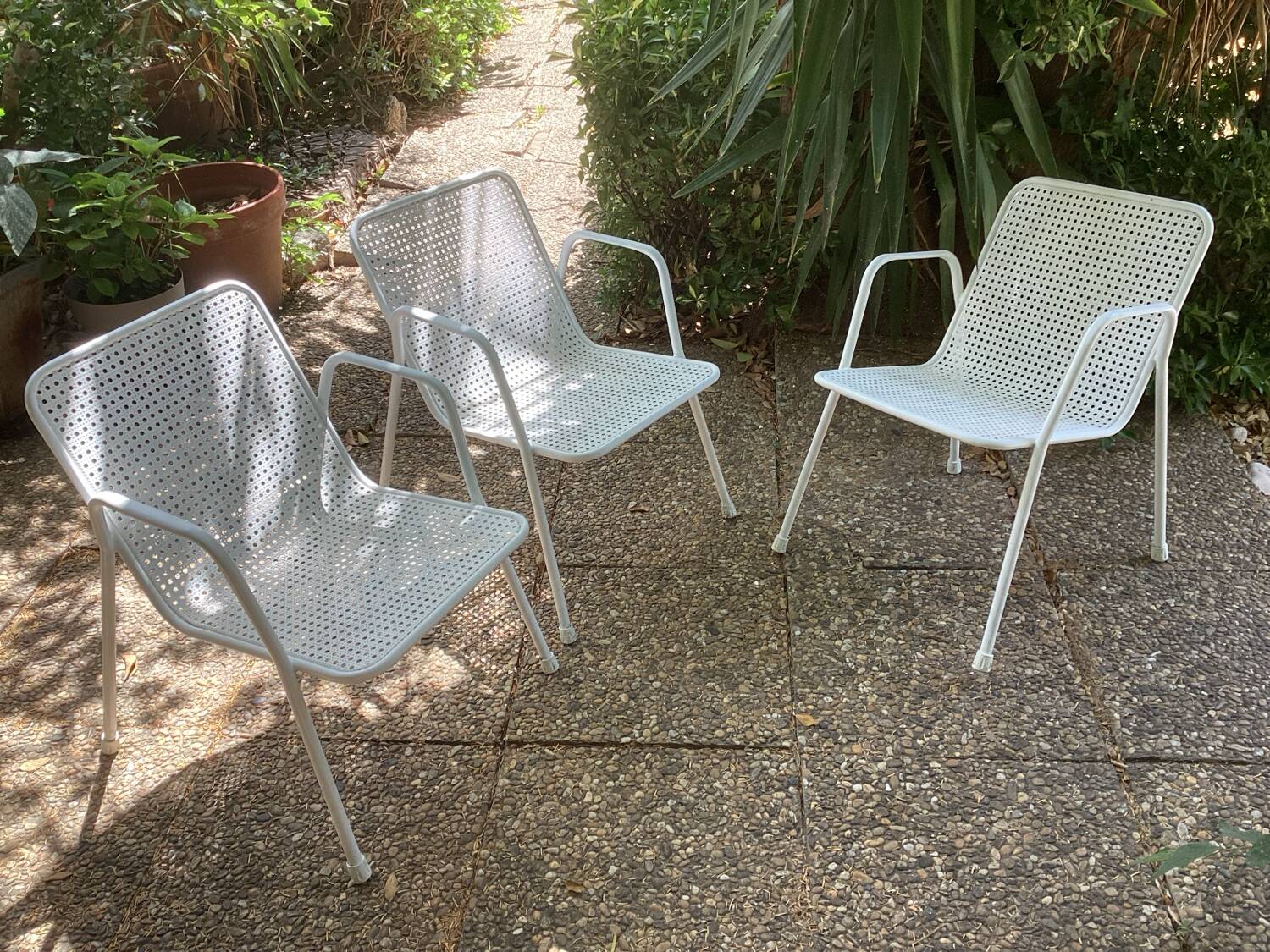 Perforated metal armchairs