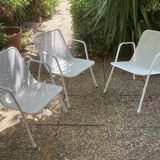 Perforated metal armchairs