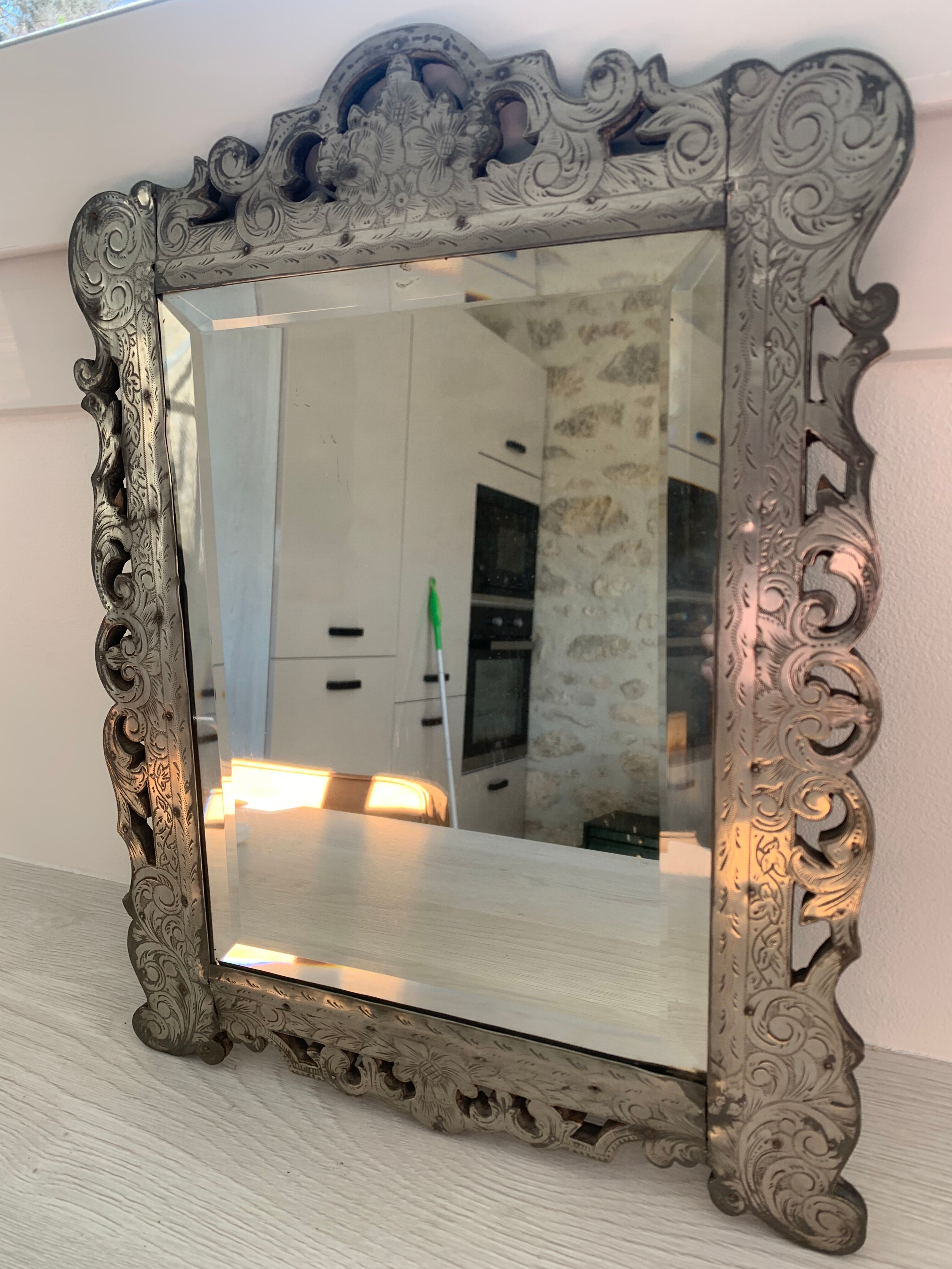 Eventful beveled mirror and openwork period 1900 repelled tin decoration