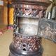 Old compact wood stove in enamelled cast iron with tripod feet with Lion's legs