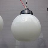 Trio of opal glass and bakelite globe pendant lights