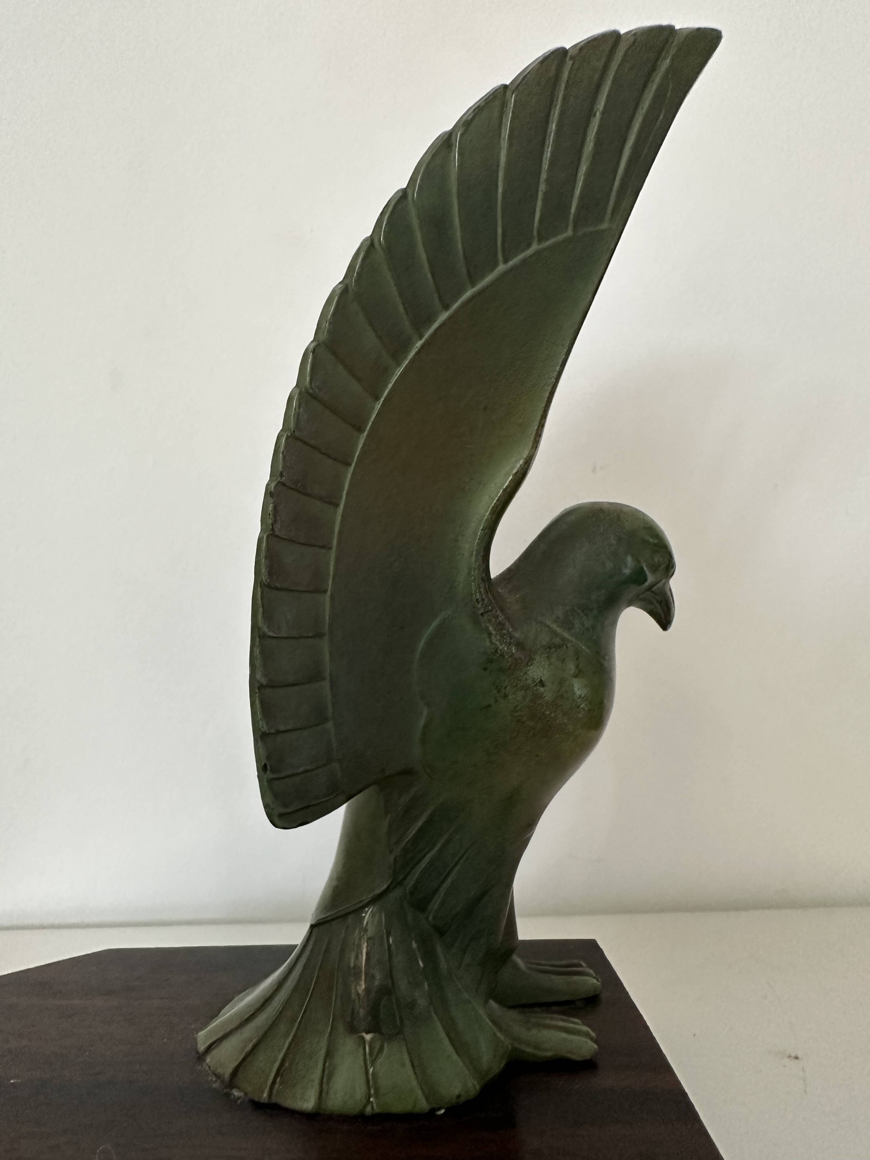 Pair of eagle bookends in green patina regula with rosewood base