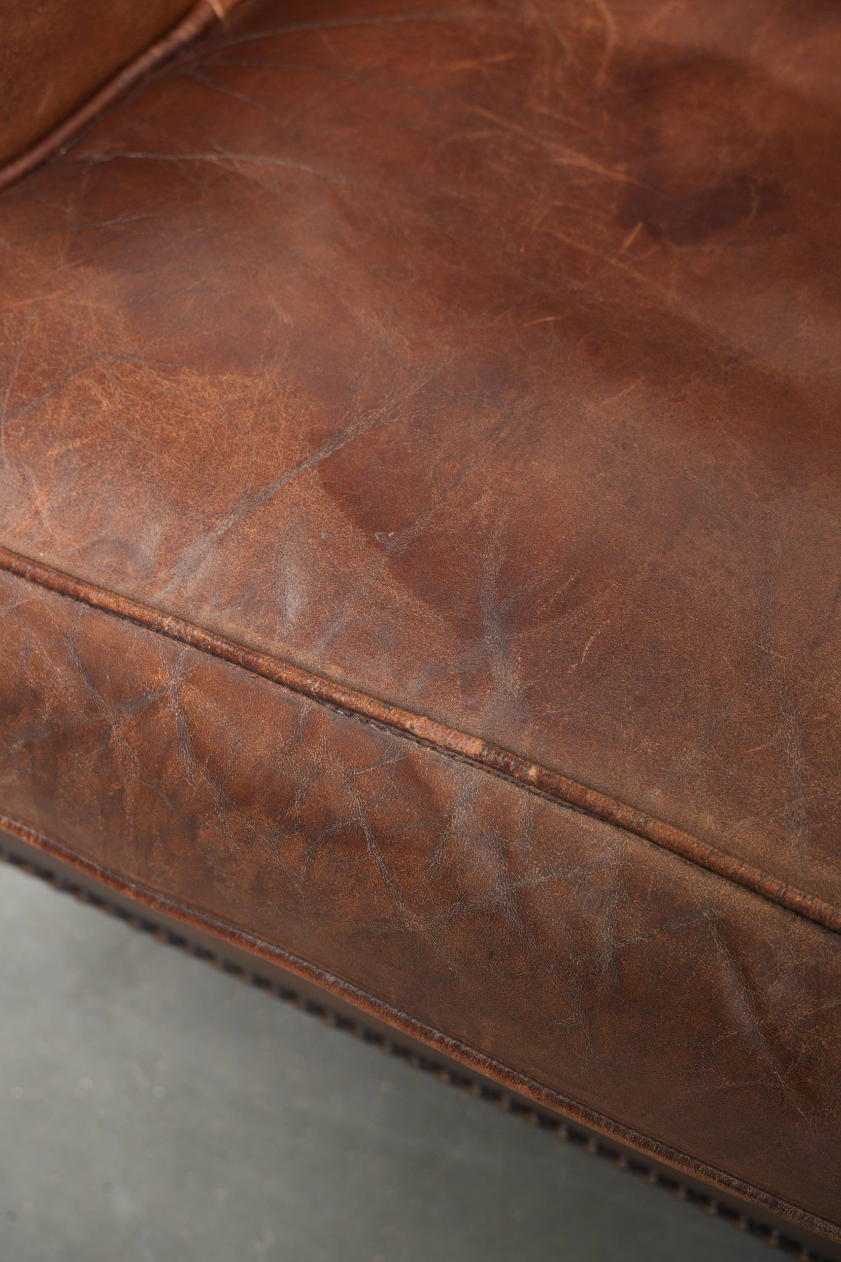 Subtle dark brown sheepskin wingback armchair with a timeless look subtle