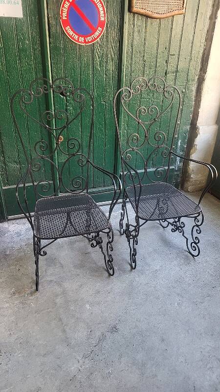 Pair of black wrought iron armchairs
