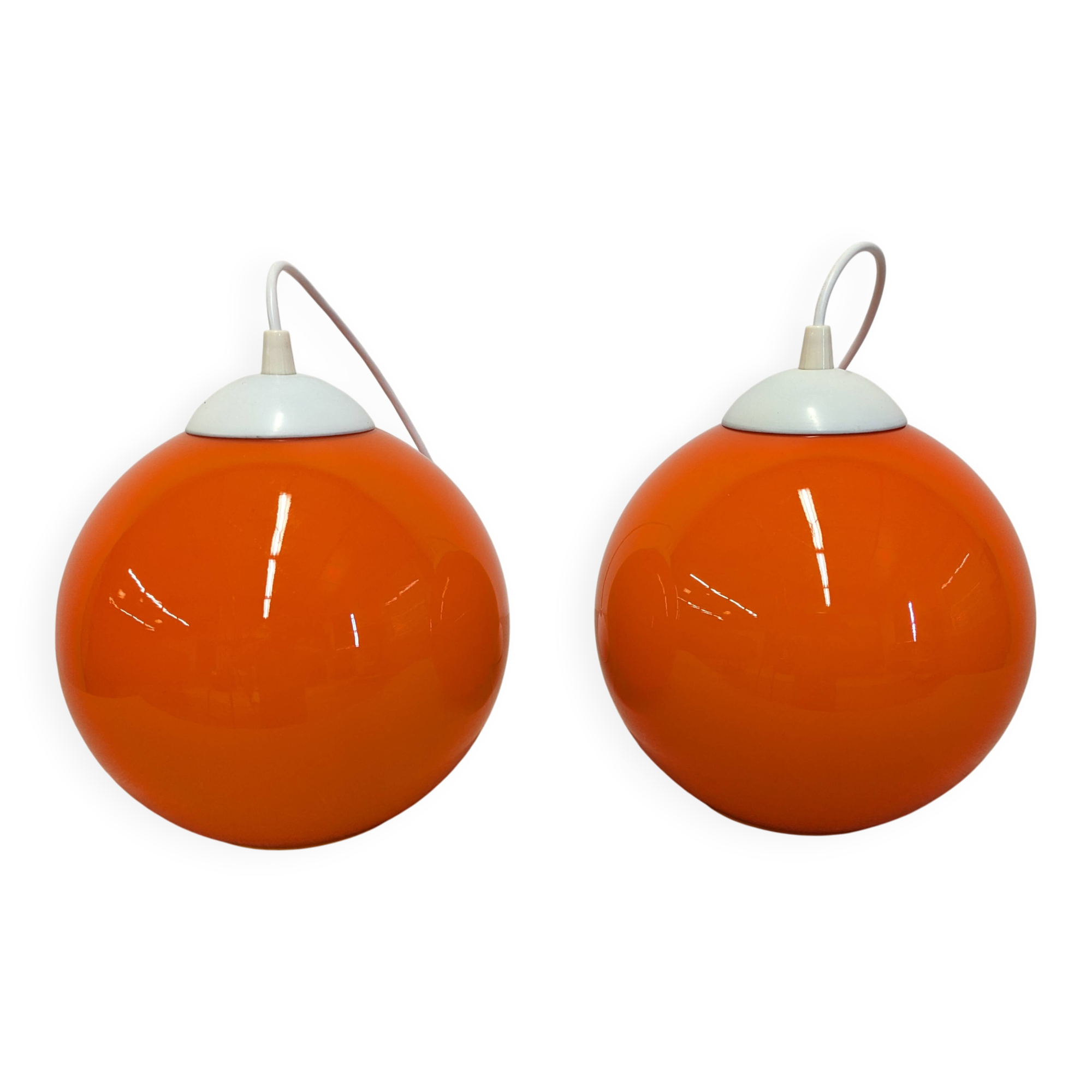 Pair of spherical pendant lights in orange opaline, France circa 1970.