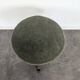Green velvet piano stool with a turned leg.