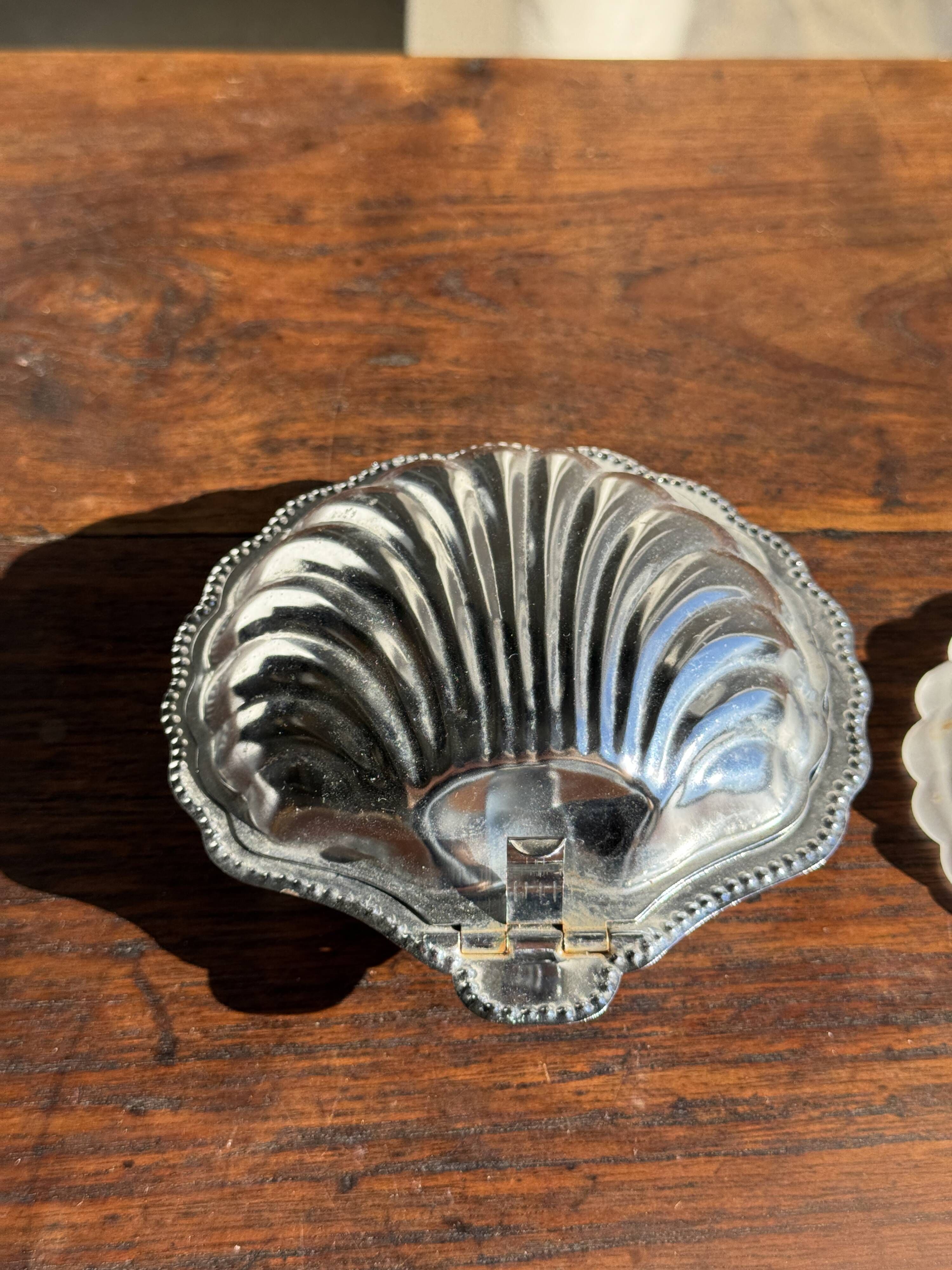 Vintage silver-plated shell butter dish with transparent bowl.