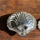 Vintage silver-plated shell butter dish with transparent bowl.