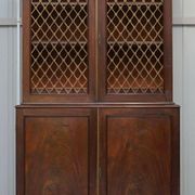 19th-century hardwood library with bronze metal doors and a chest of drawers.