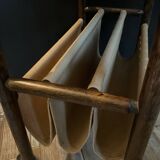 Vintage rattan magazine rack on wheels