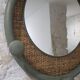 Round decorative mirror in sage green and rattan – Chic country style