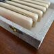 12 vintage stainless steel knives bone or bakelite sleeves in case
