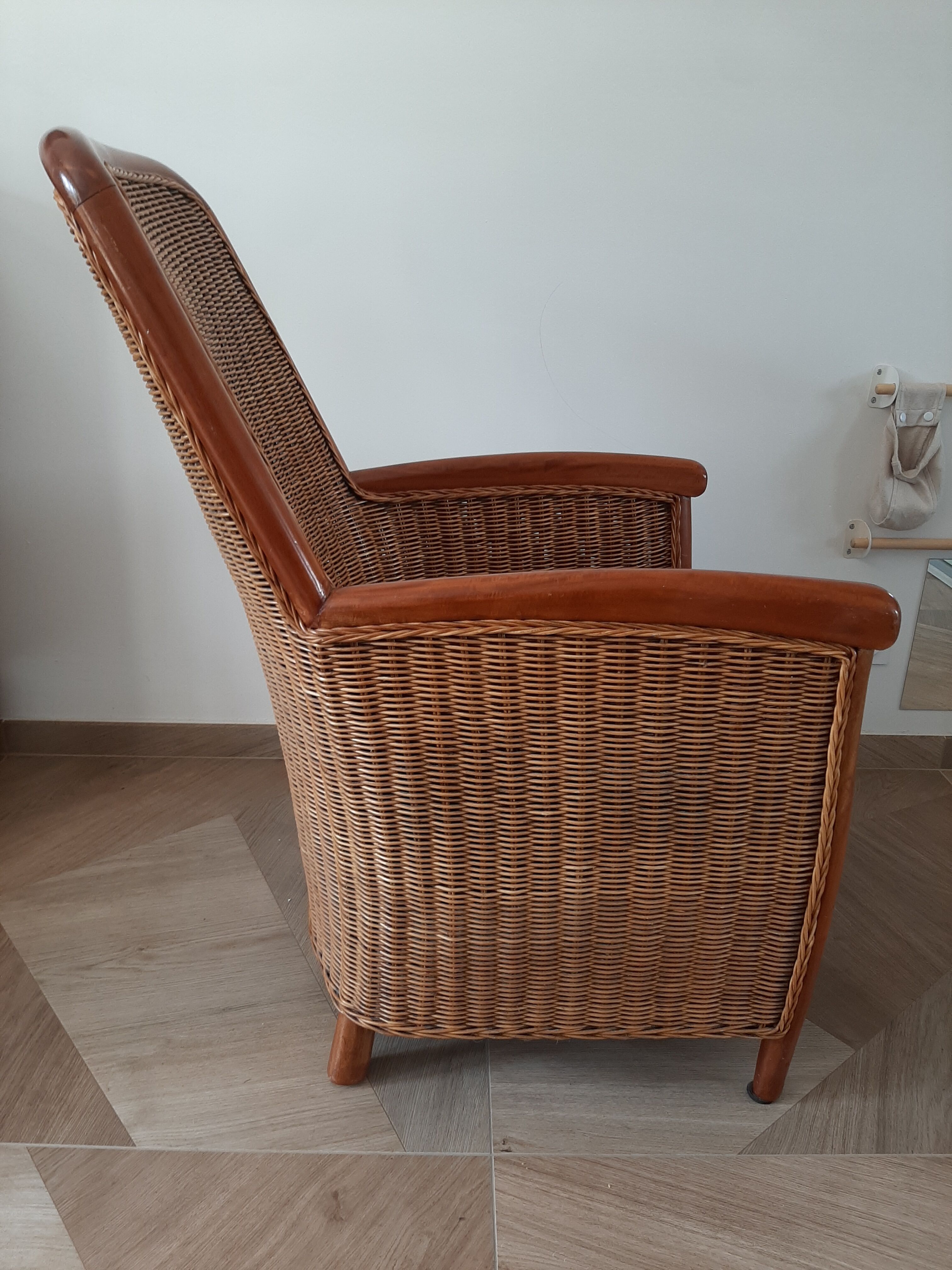 Armchair in woven rattan and exotic wood