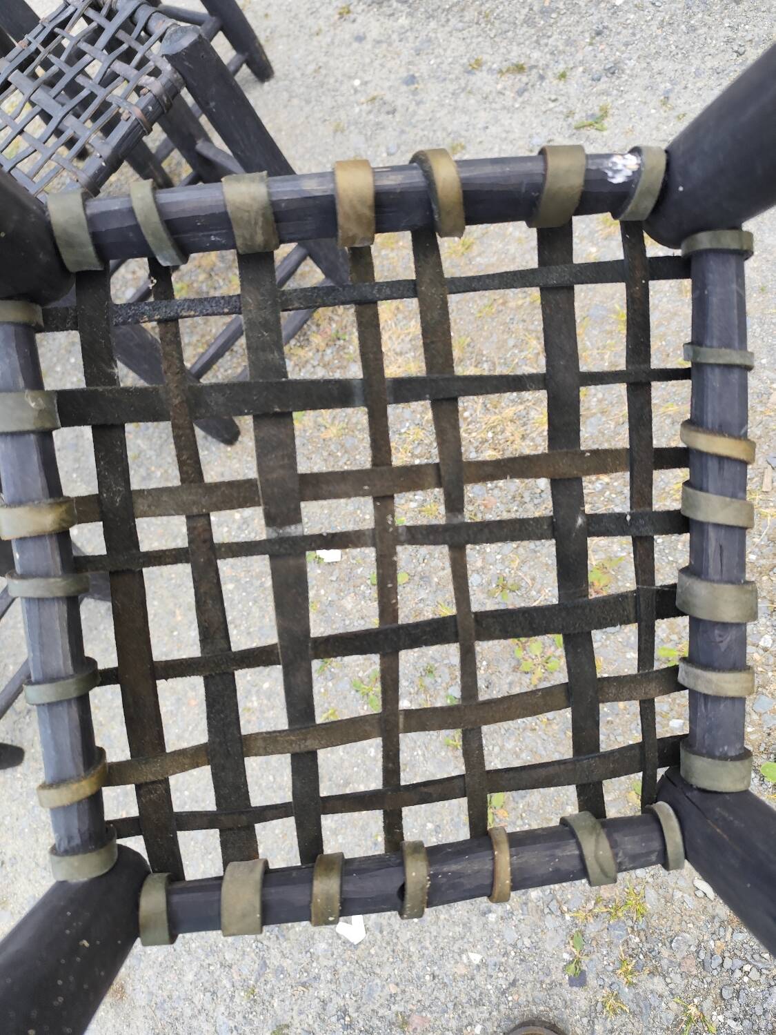 5 blackened wooden stools with woven leather seats by Nina Kaufmann