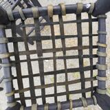 5 blackened wooden stools with woven leather seats by Nina Kaufmann