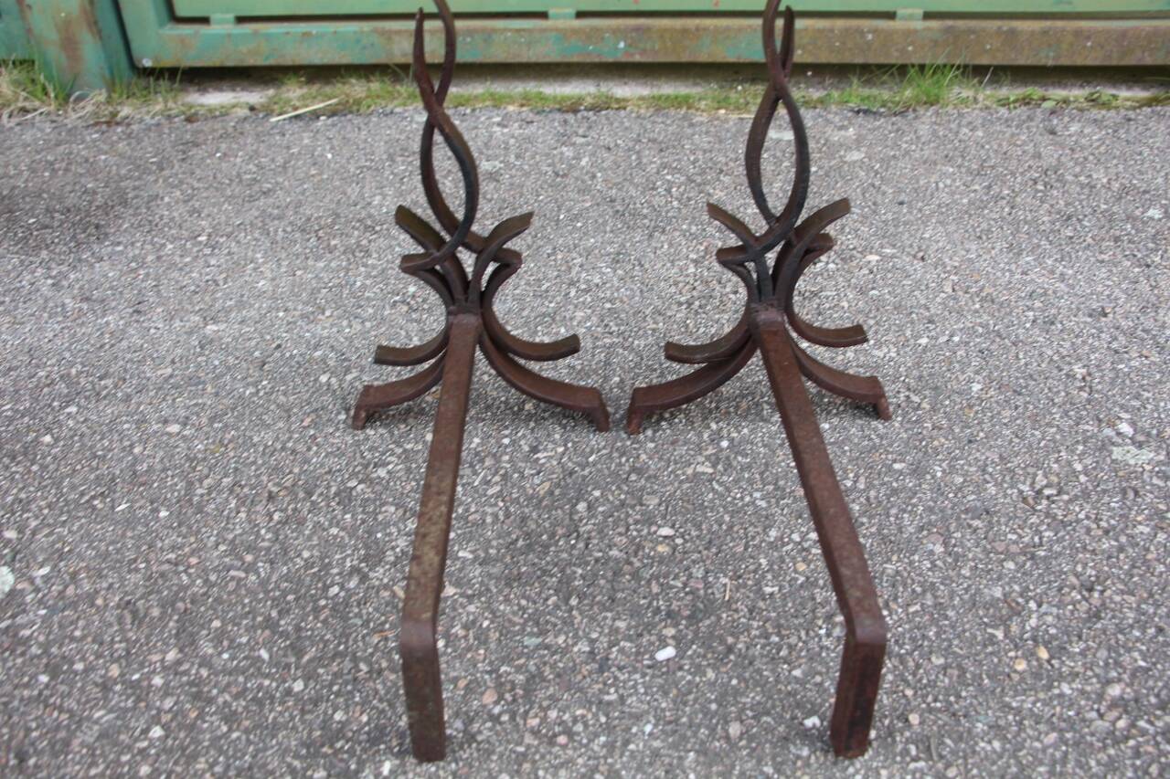 pair of andirons attributed to Raymond Subes, flame model