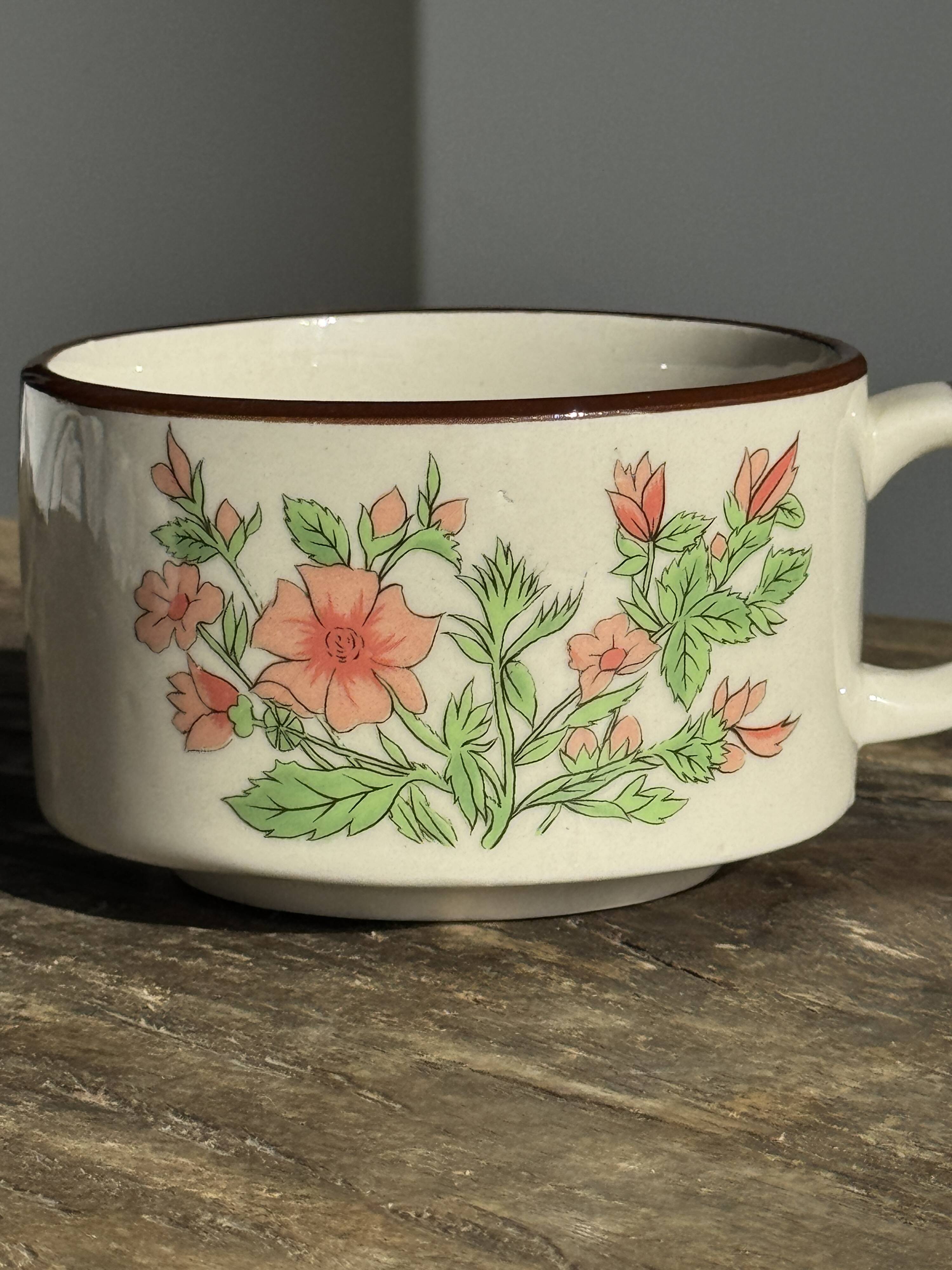 Small speckled stoneware cup made in Korea with a floral pattern H7 D11