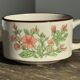 Small speckled stoneware cup made in Korea with a floral pattern H7 D11