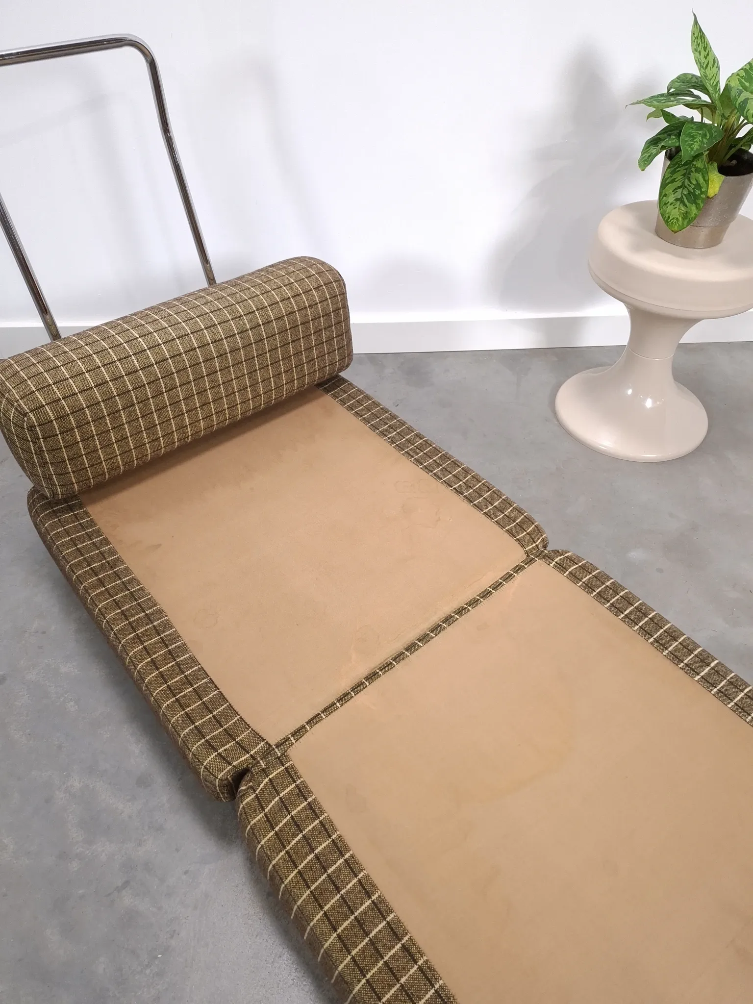 Vintage pull-out sofa bed, brown checked lounge chair with chrome.