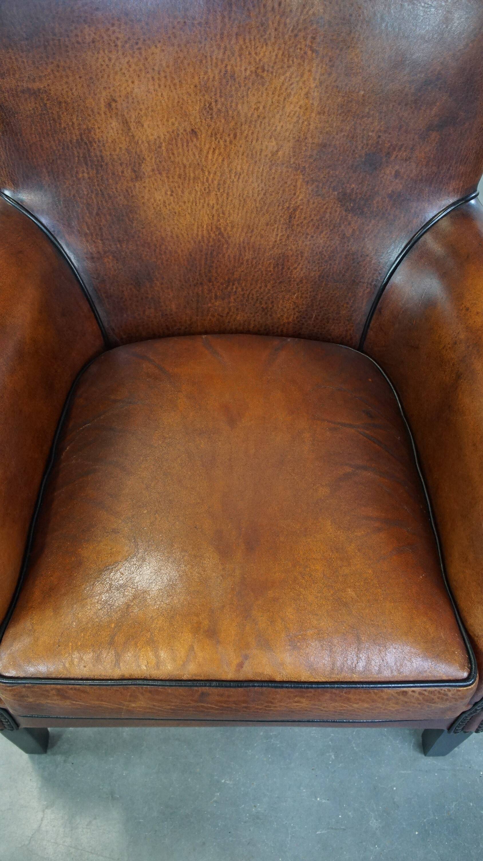 Sheepskin armchair/lounge chair finished with decorative nailheads