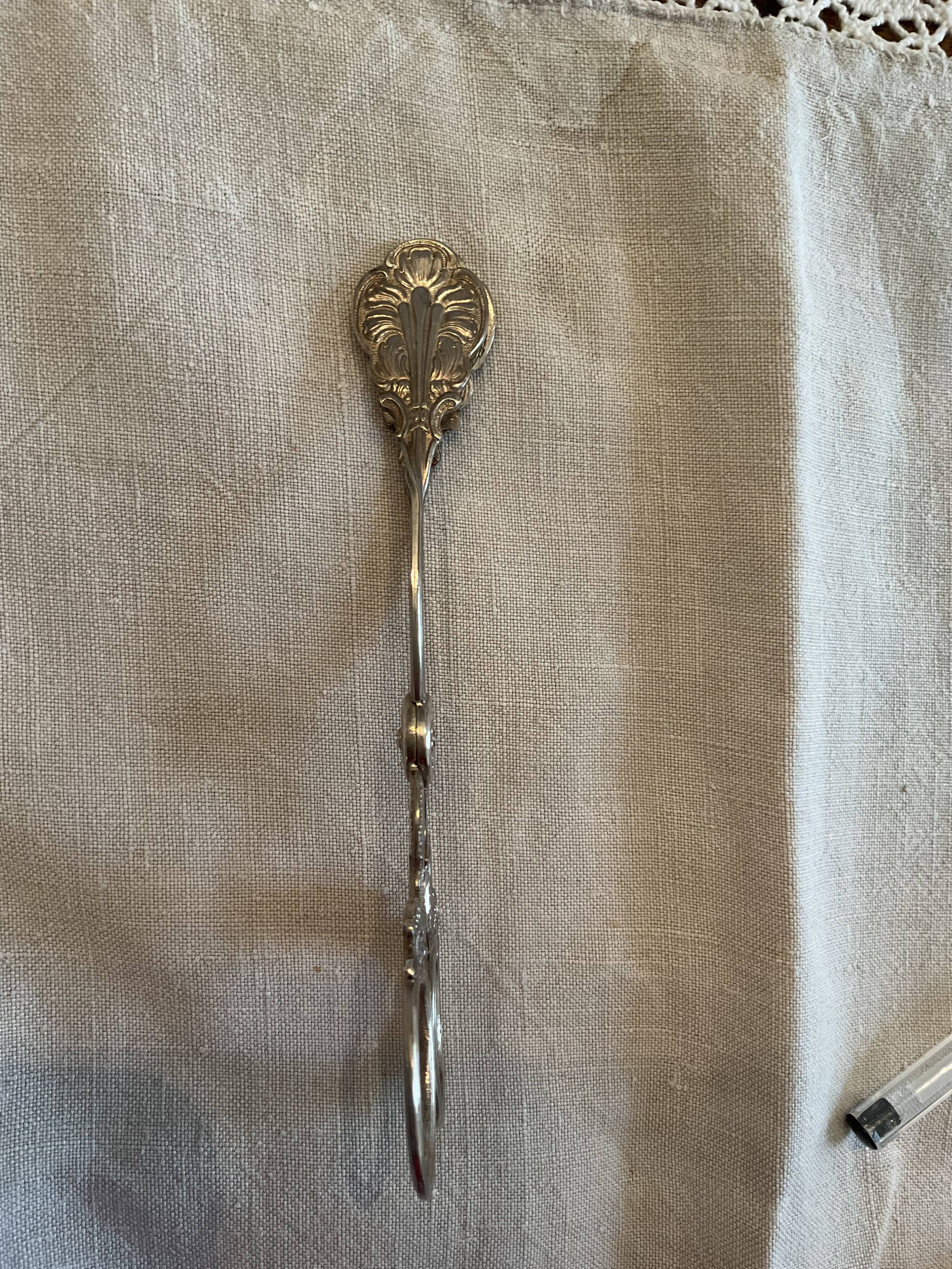 Sugar tongs or sweets in silver metal