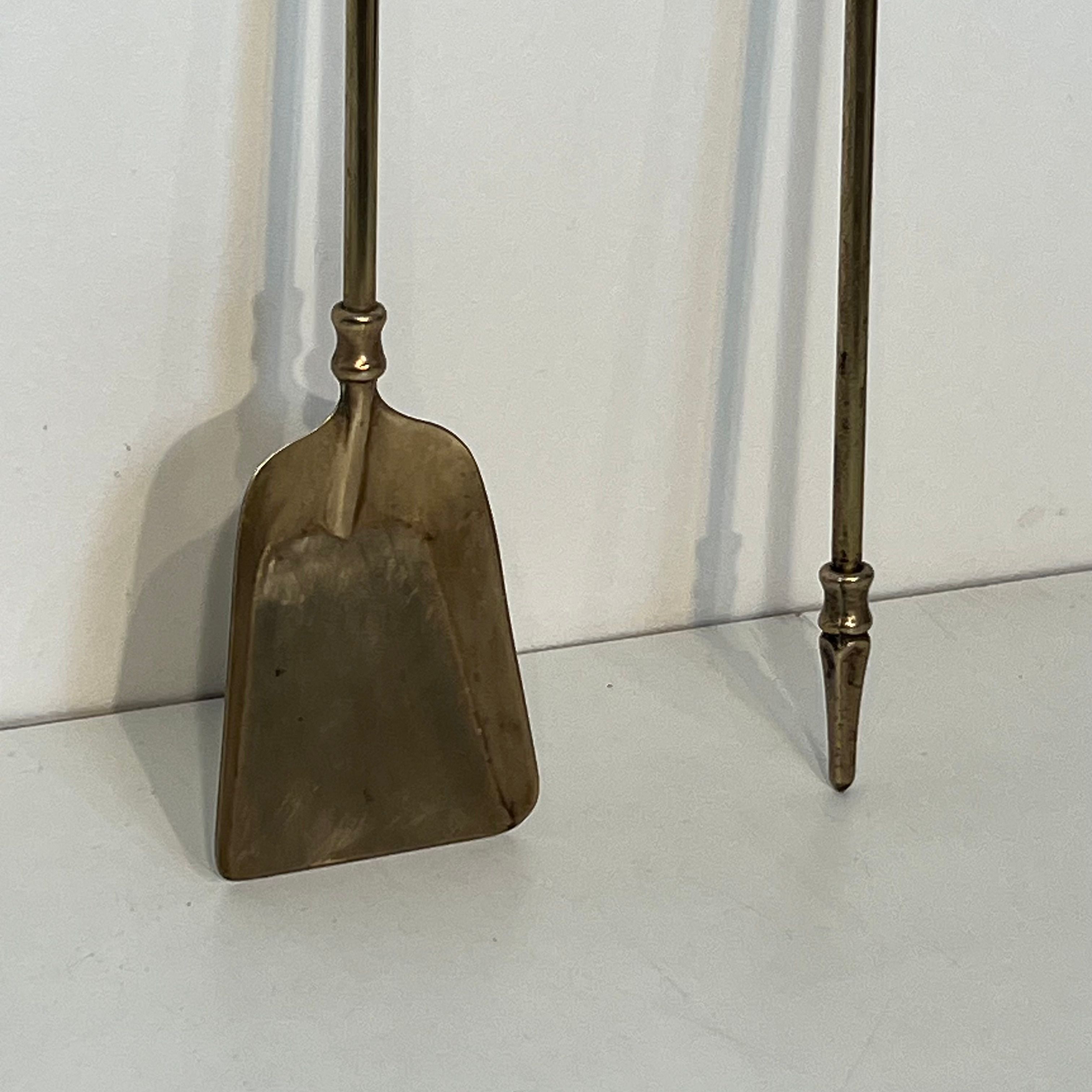 Neoclassical brass fire accessory.