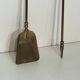 Neoclassical brass fire accessory.