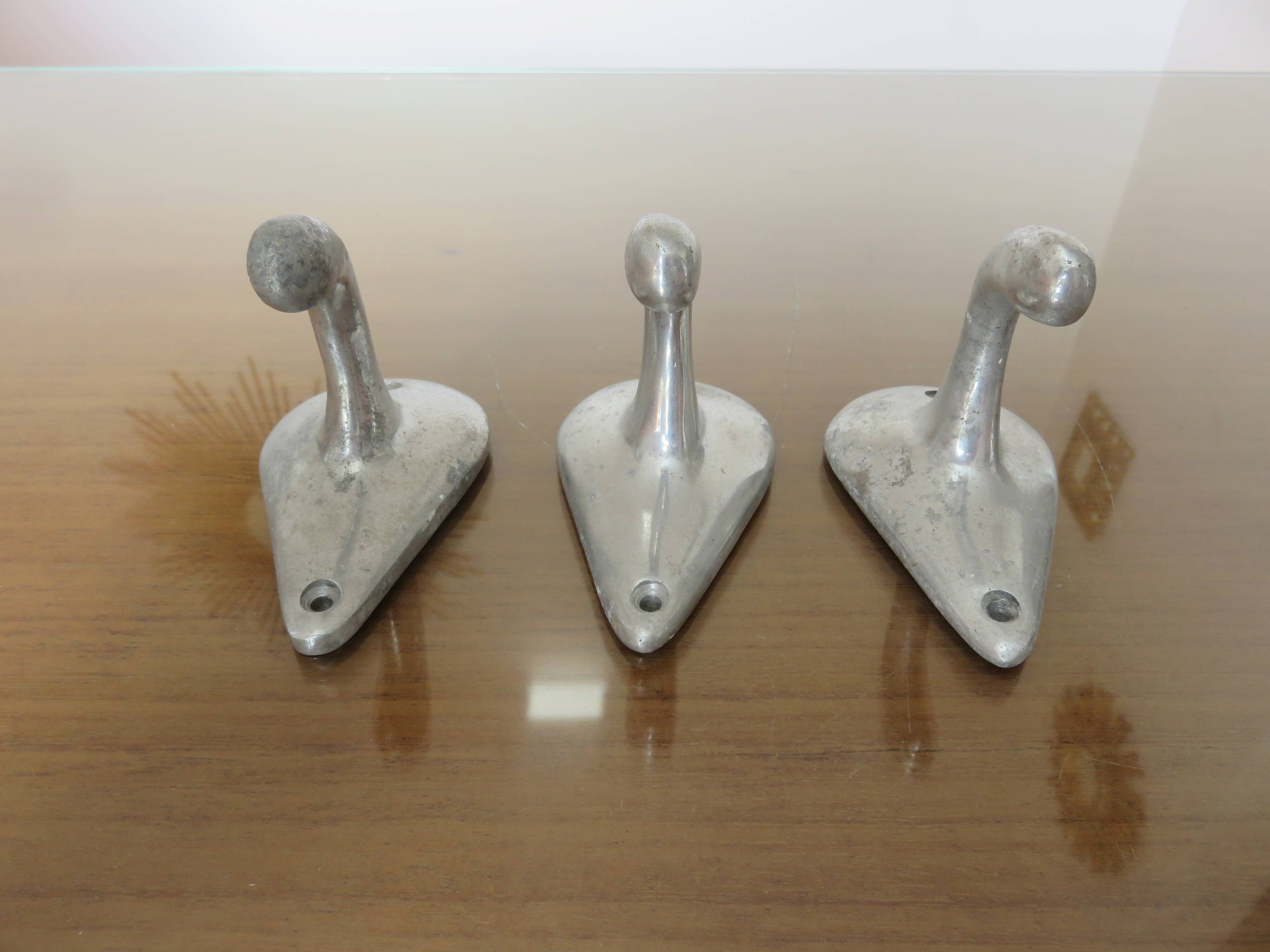 Series of 3 "streamline" aluminum coat hooks from the 60s and 70s