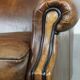 Vintage sheepskin wingback chair finished with black piping