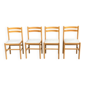 4 solid wood and white leather chairs