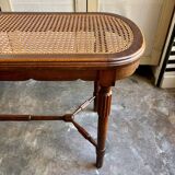 Piano bench in dark wood and cane