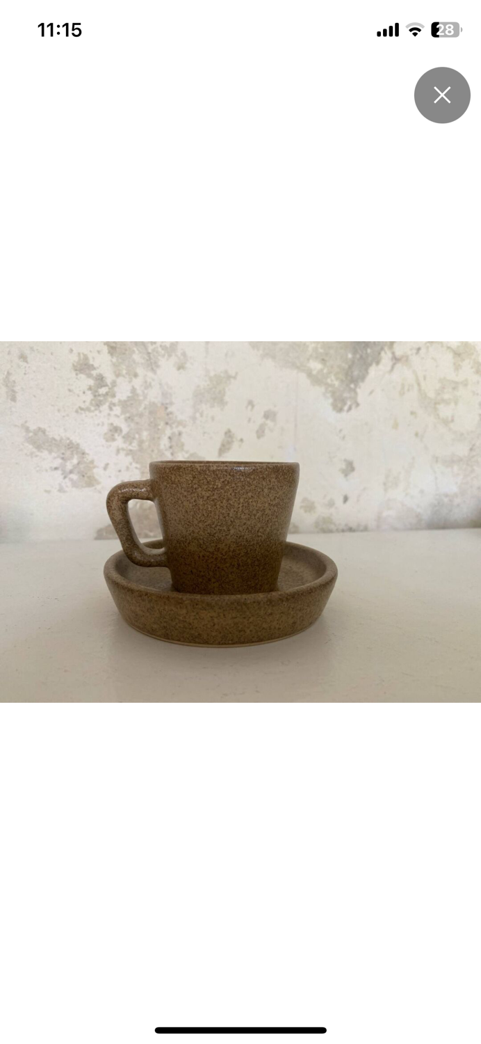 Set of stoneware coffee cups with saucers.