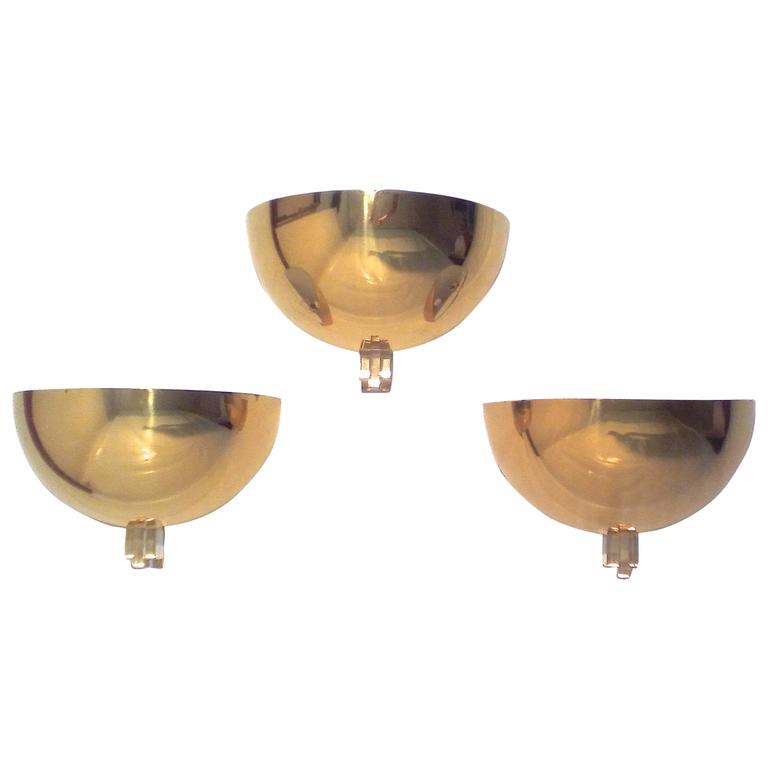 Three brass and lucite wall lights