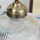 Swan neck wall light in brass with a ribbed glass shade, Holophane type.