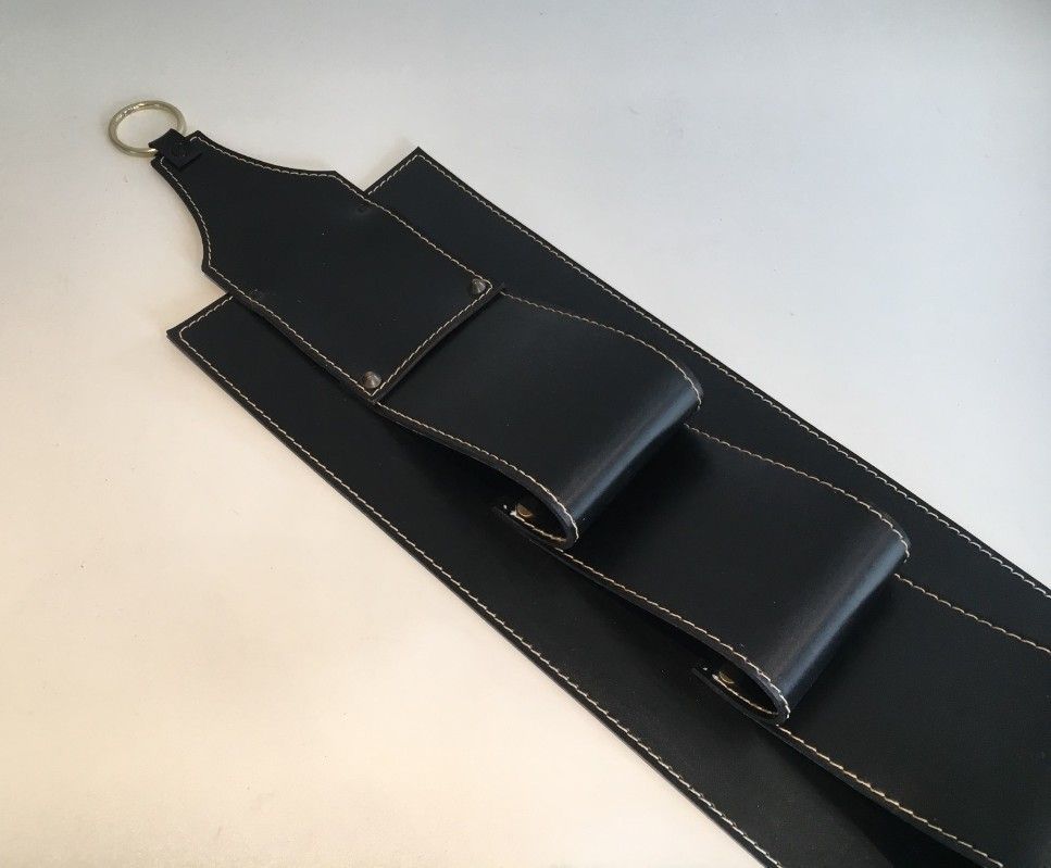 Leather wall-mounted magazine rack. Attributed to Jacques Adnet