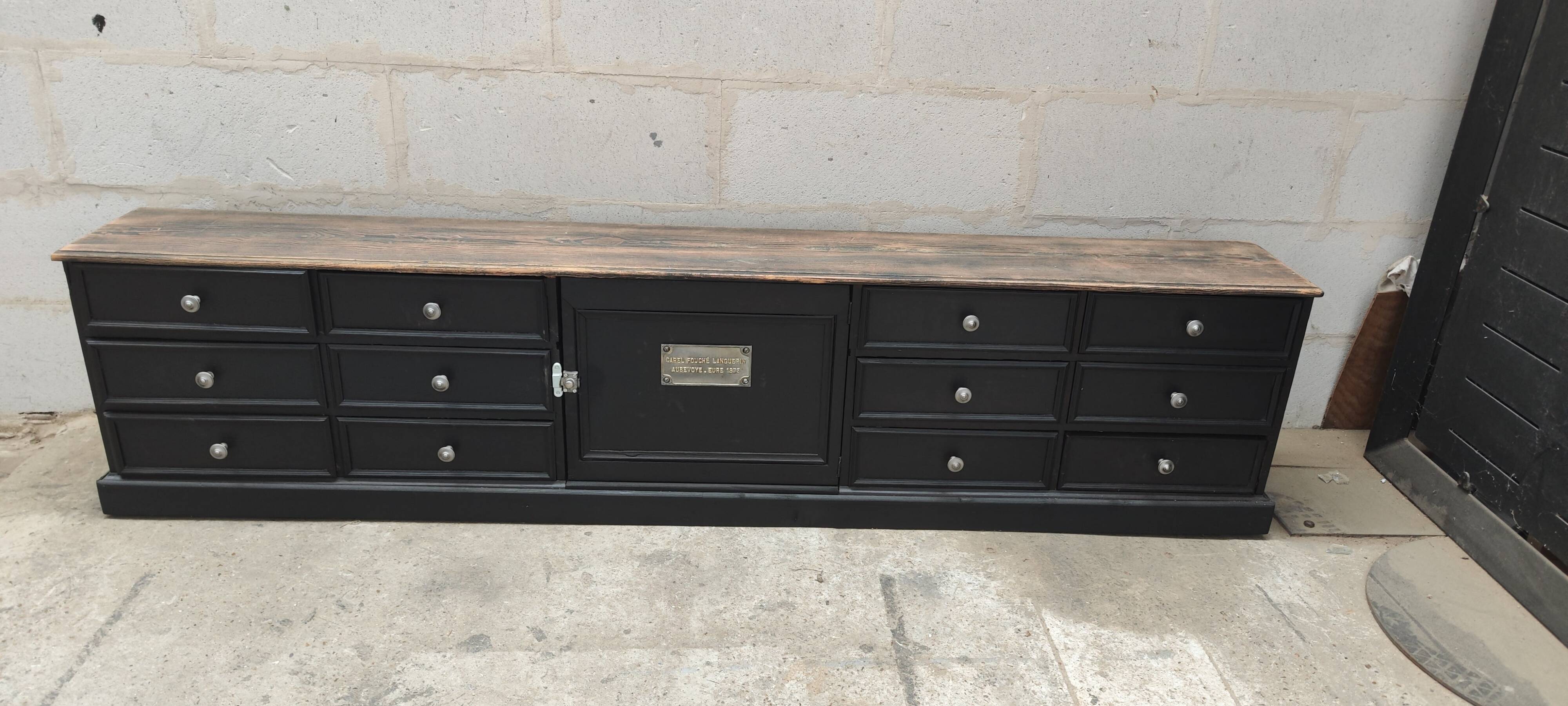 Low TV cabinet with black patina, twelve drawers and one door