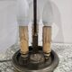 Three-armed brass hot water bottle lamp with empire green shade