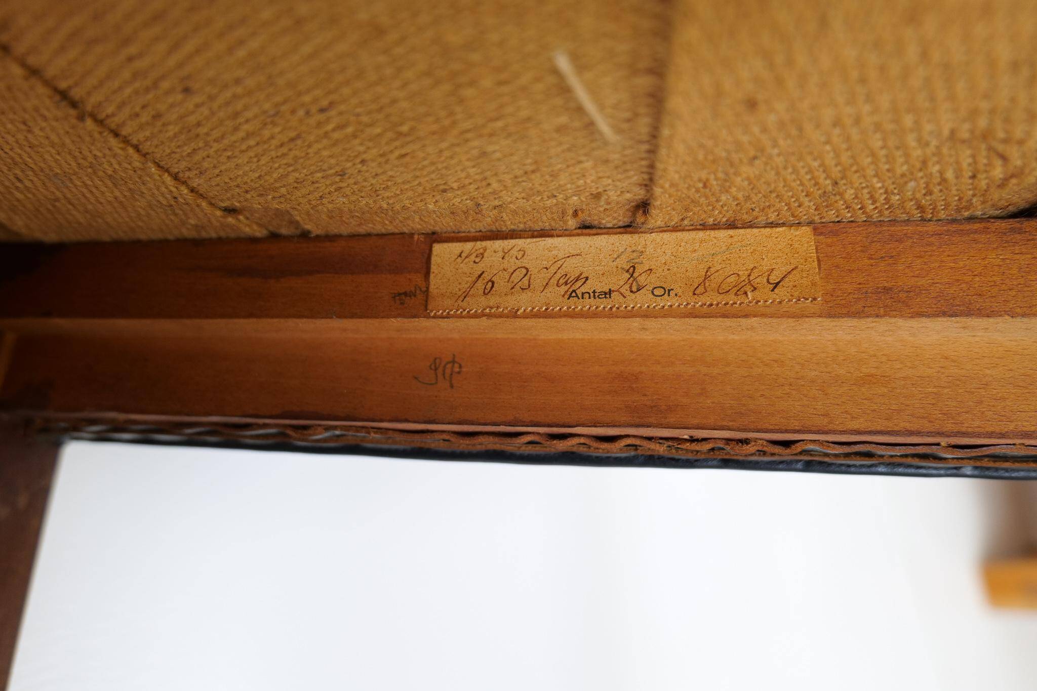 Mid-century armchair by Ole Wanscher for Fritz Hansen, stained beech and leather.