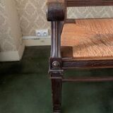 Antique armchair in carved wood and straw seat