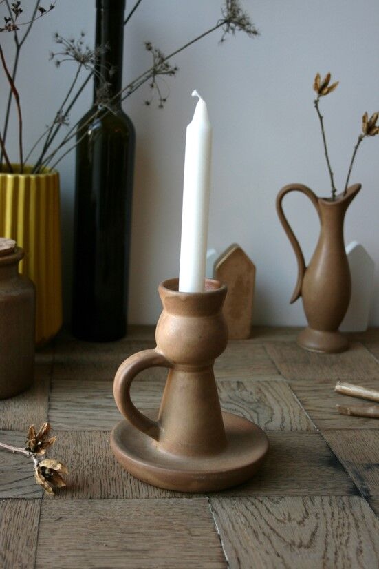 Hand-held sandstone candlestick