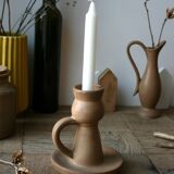 Hand-held sandstone candlestick