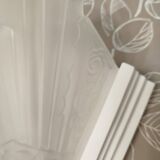 Pair of Art Deco wall sconces in plaster and pressed glass.