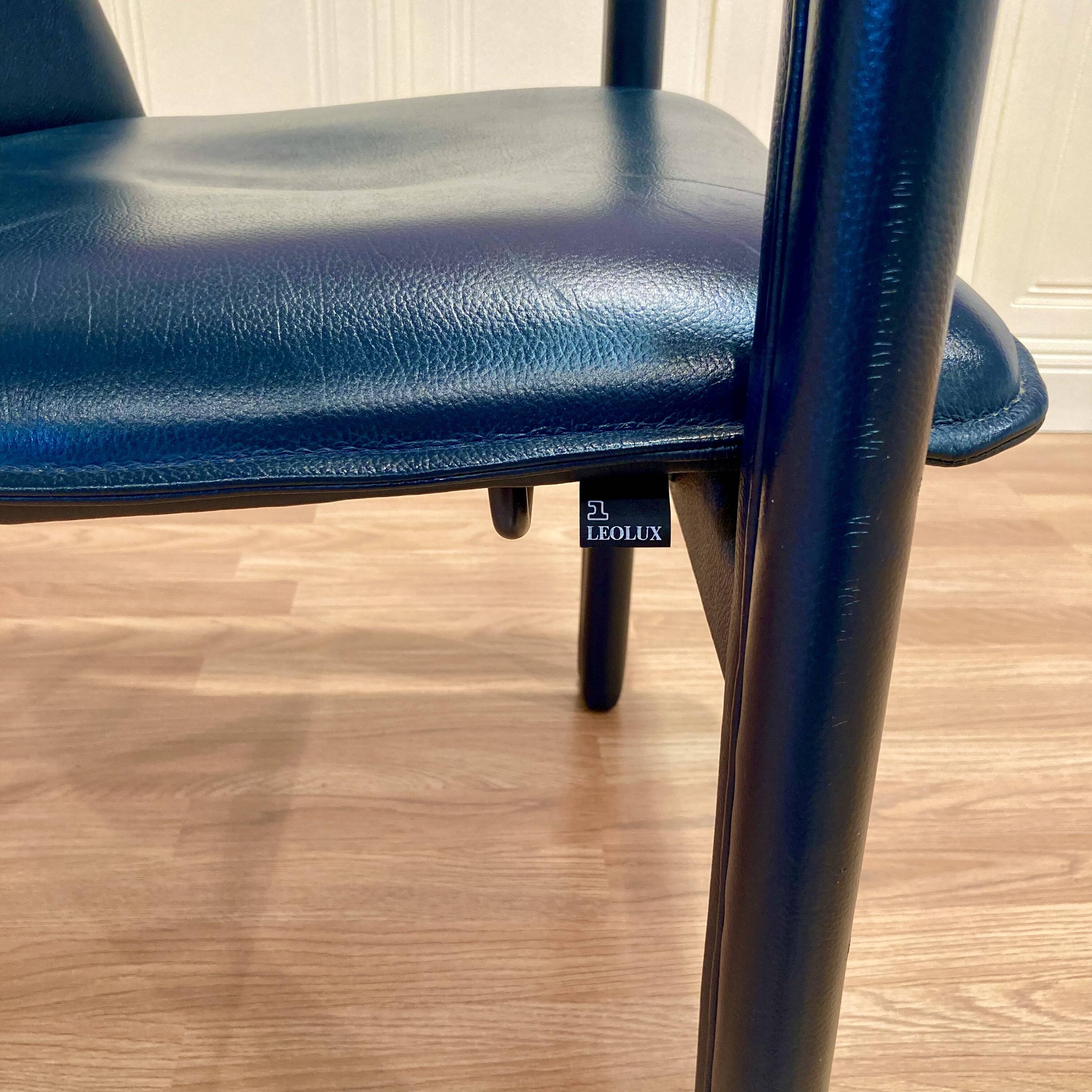 Set of 3 designer leather and metal armchairs.